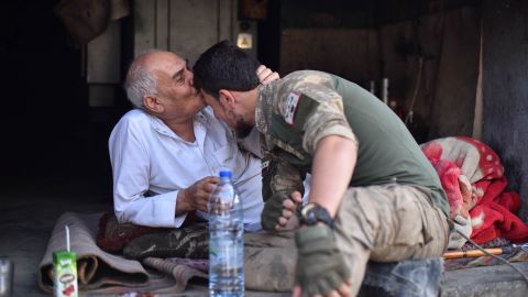 A local resident of Ras al-Ain kisses the forehead of a member of the Turkish-backed Free Syrian Army on October 17. 