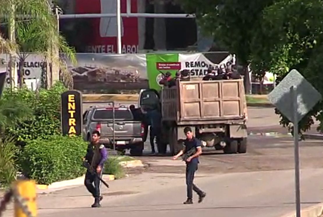 Gunmen are seen in a Culiacan street Thursday.