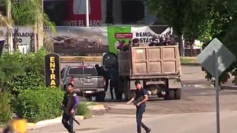 Gunmen are seen in a Culiacan street Thursday.