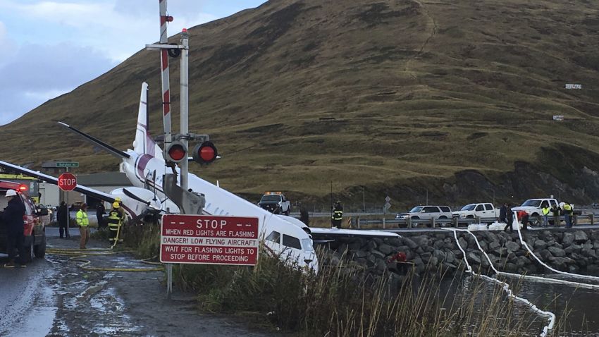 A commuter airplane has crashed near the airport in a small Alaska community on the Bering Sea, Thursday, Oct. 17, 2019, in Unalaska, Alaska. Freelance photographer Jim Paulin says the crash at the Unalaska airport occurred Thursday after 5 p.m. Paulin says the Peninsula Airways flight from Anchorage to Dutch Harbor landed about 500 feet (152 meters) beyond the airport near the water. (Jim Paulin via AP)