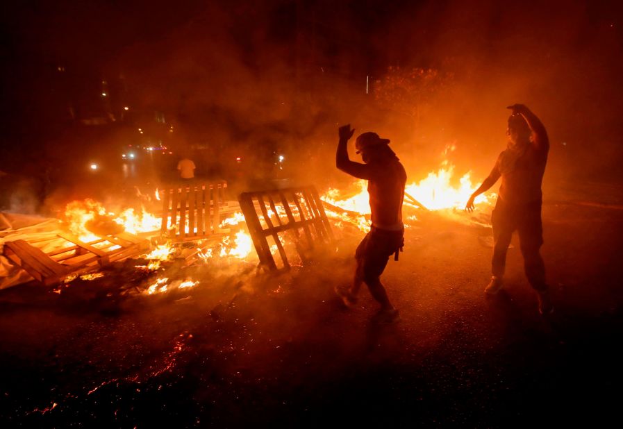 Lebanese demonstrators burn wood and debris on Thursday, October 17.