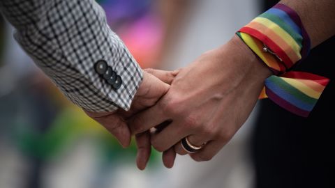 A same-sex couple hold hands during an event to raise awareness of gay rights in Hong Kong