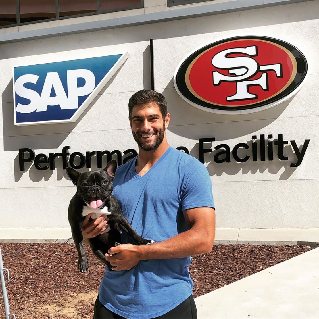 Quarterback Jimmy Garoppolo hangs with Zoë at the Niner's training facility.