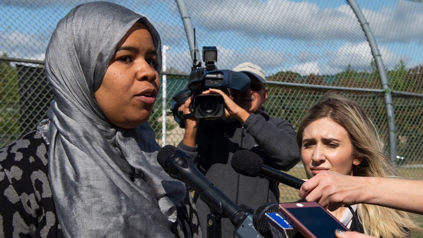 Madinah Brown, speaking to reporters Thursday, says her supervisors ask her to remove her hijab or go home