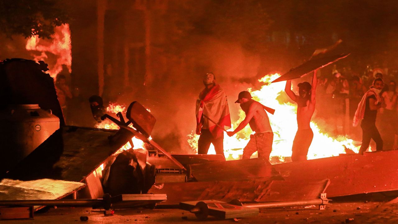 Lebanese demonstrators stand by a fire as they erect a make-shift barricade in Riad al-Solh Square, Beirut, on Friday.