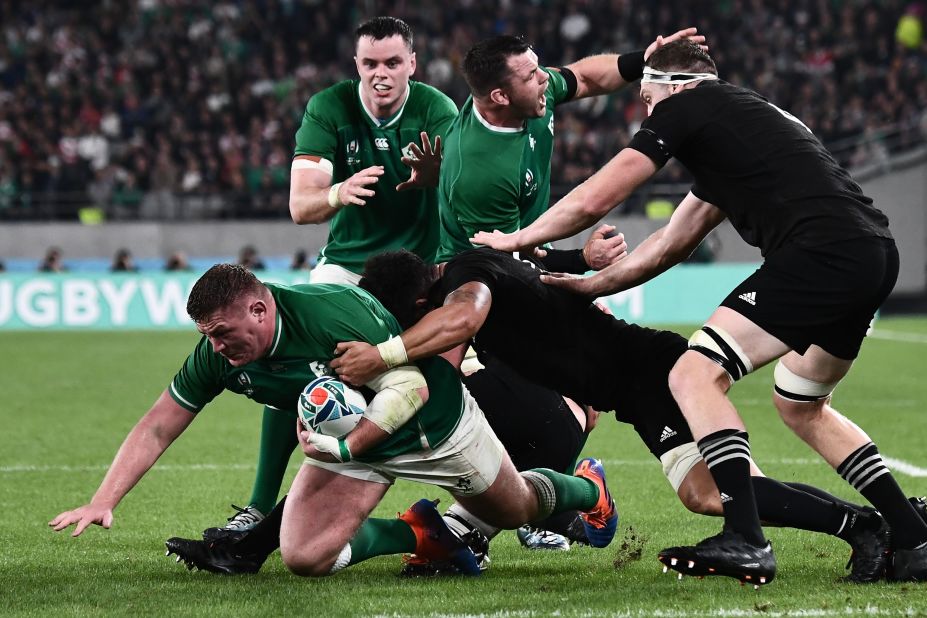 Ireland's prop Tadhg Furlong (L) is tackled.