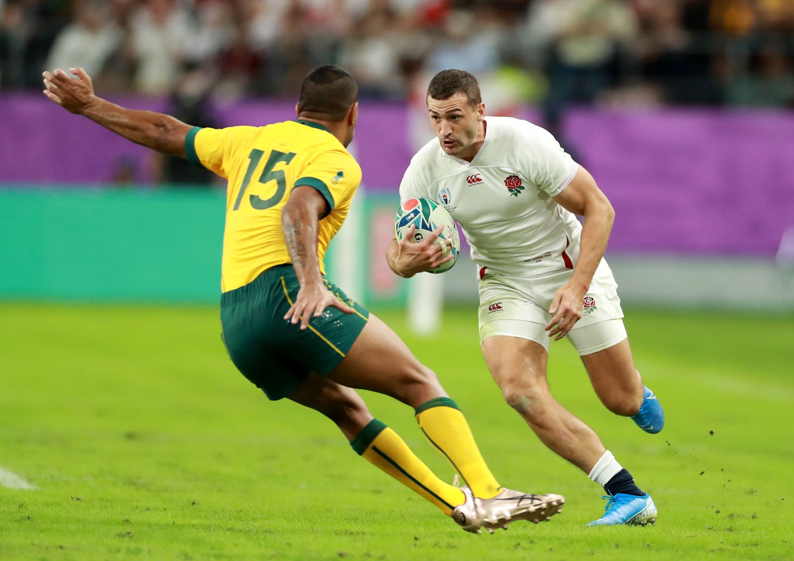 Jonny May of England takes on Kurtley Beale of Australia.