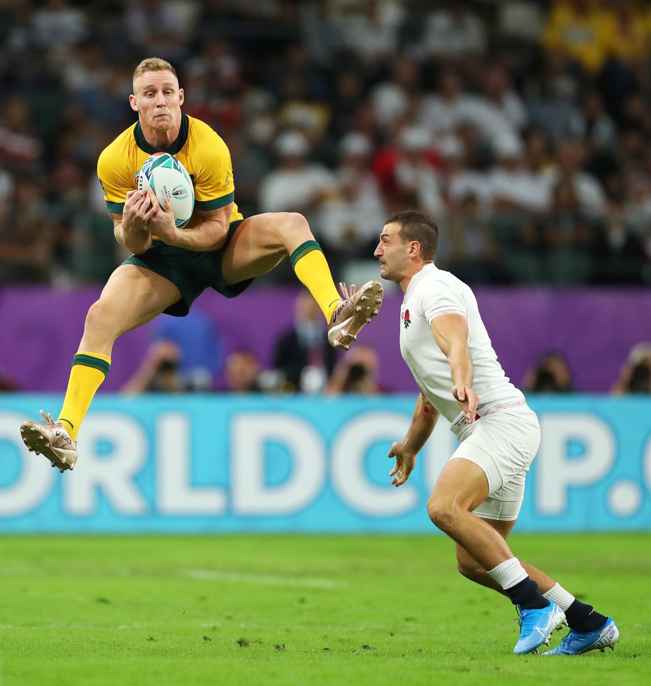 Reece Hodge of Australia claims a high ball under pressure from Jonny May of England.