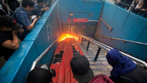 Protesters burn an entrance to Santa Lucia metro station in Santiago on Friday.