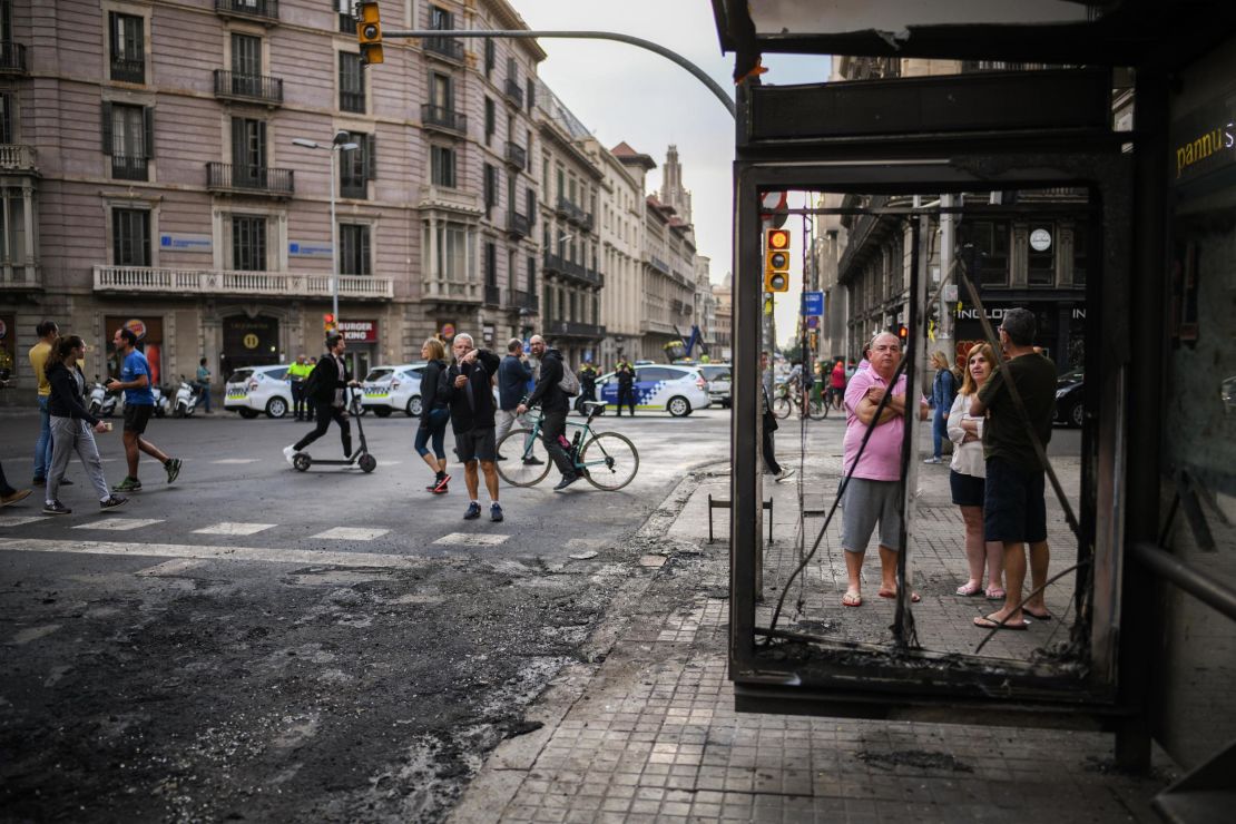Members of the public view the damage on Saturday after the night of rioting in Barcelona.