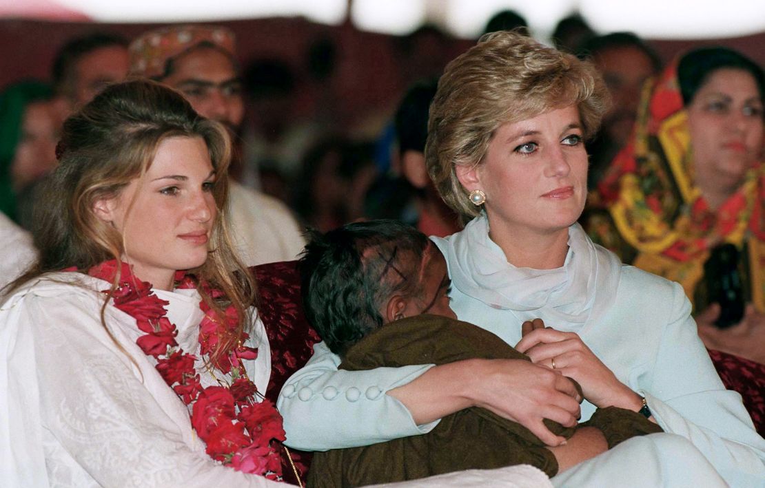 Diana, Princess of Wales, cradles a sick child as she sits beside Jemima Khan at Imran Khan's cancer hospital in 1996.
