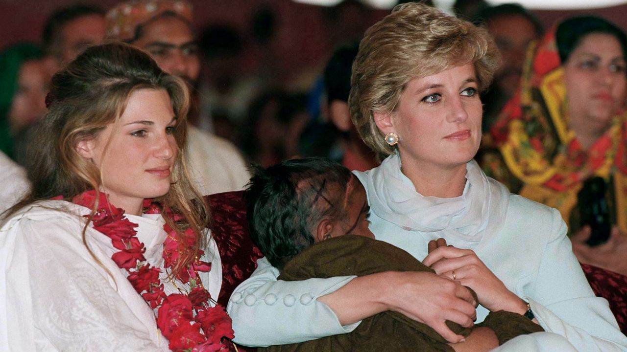 Diana, Princess of Wales, cradles a sick child as she sits beside Jemima Khan at Imran Khan's cancer hospital in 1996.