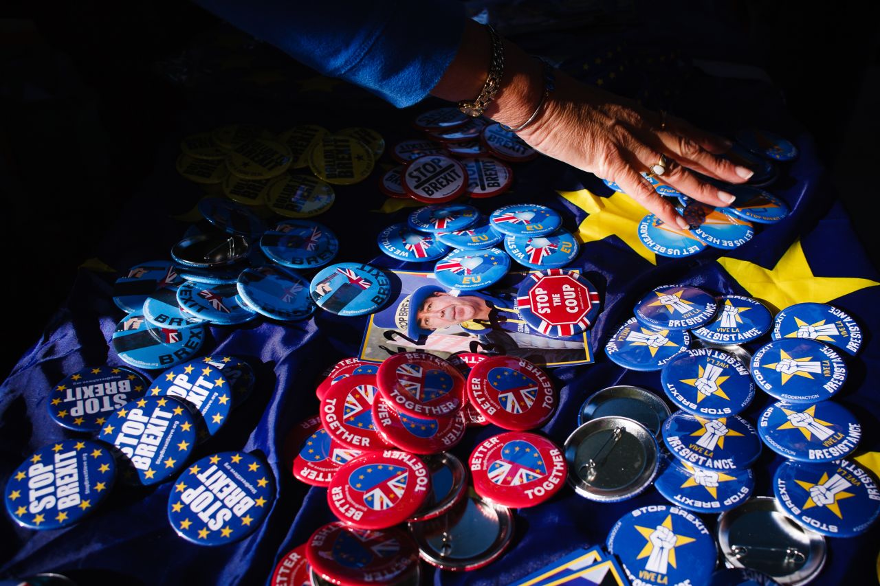 Anti-Brexit buttons rest on a table covered with an EU flag in central London. 
