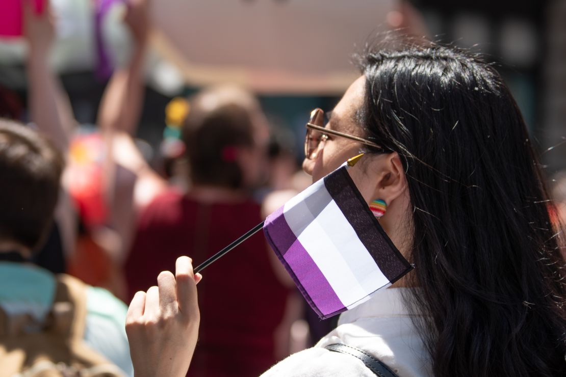 A woman waves the asexual pride flag at WorldPride parade in New York on June 23.