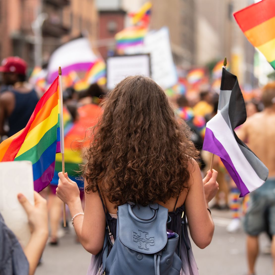 A woman carries the rainbow flag and the asexual pride flag at the WorldPride parade in New York on June 23.