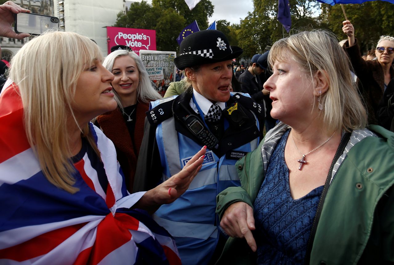 Pro-Brexit and anti-Brexit demonstrators argue at Parliament Square as lawmakers in the House of Commons debate nearby. 