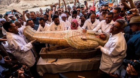 Egyptian archeologist open a coffin belonging to a man in front Hatshepsut Temple in Luxor on October 19, 2019.