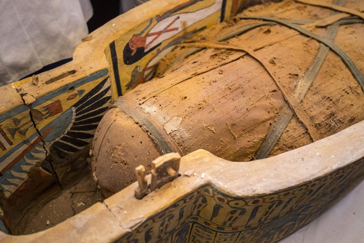An open coffin displayed in Luxor reveals a mummy.