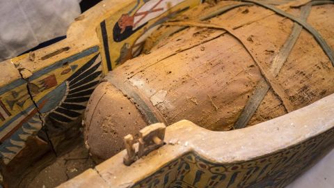 An open coffin displayed in Luxor reveals a mummy.