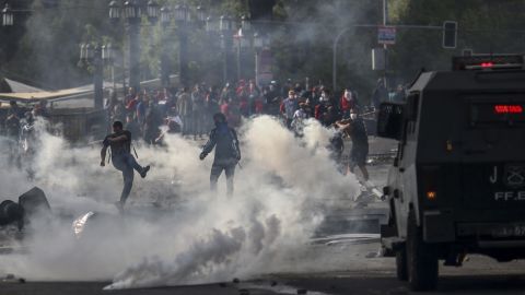 Demonstrators chash with soldiers in Santiago on Saturday.