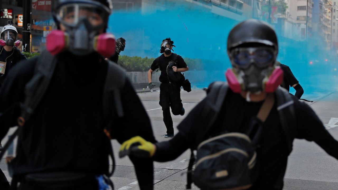 Police fire blue dye toward protesters in Hong Kong on Sunday, October 20. Blue dye can be used to stain and identify masked protesters.