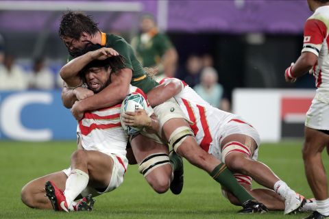 Japan's Shota Horie is tackled by South Africa's Eben Etzebeth.