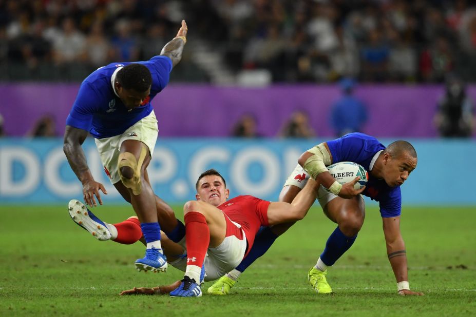 France's Gael Fickou battles for possession with Wales' Owen Watkin during quarterfinal at Oita Stadium.