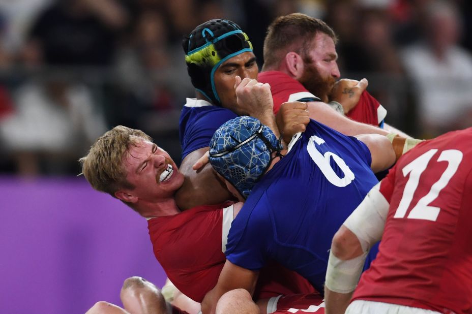 France's lock Sebastien Vahaamahina (black cap) elbows Wales' flanker Aaron Wainwright (L). Vahaamahina was red carded and his dismisall proved key as Wales took control of the match.