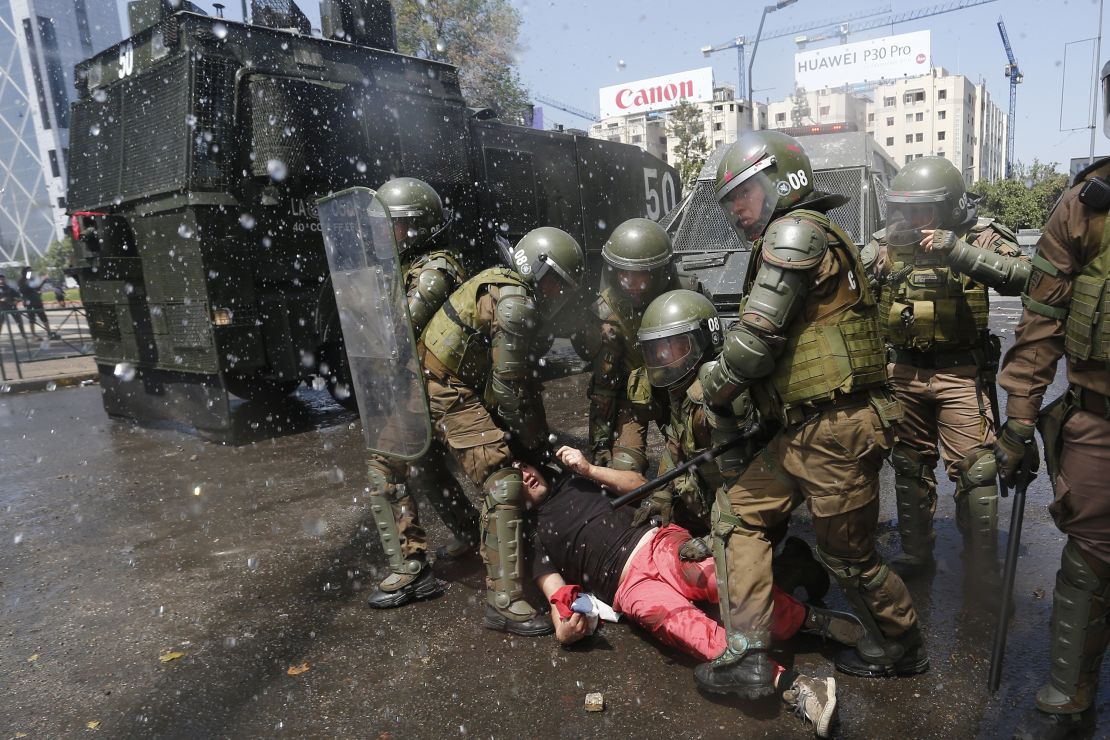 Anti-government demonstrators clash with police as they protest against cost of living increases on October 20 in Santiago, Chile.