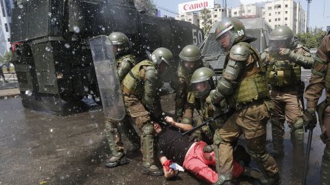 Anti-government demonstrators clash with police as they protest against cost of living increases on October 20 in Santiago, Chile.