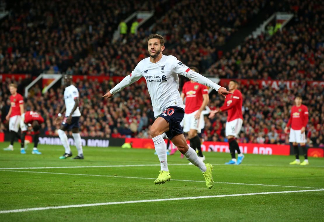 Adam Lallana celebrates scoring Liverpool's equalizer at Old Trafford.