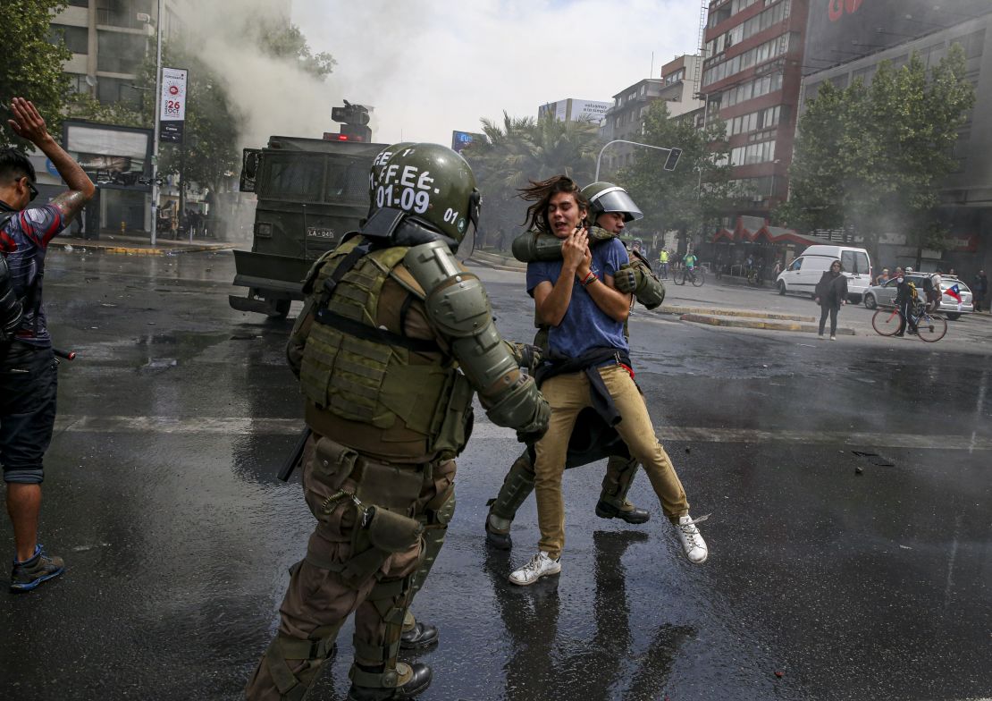 A demonstrator is detained by the police during a protest in Santiago, Chile, on Saturday.