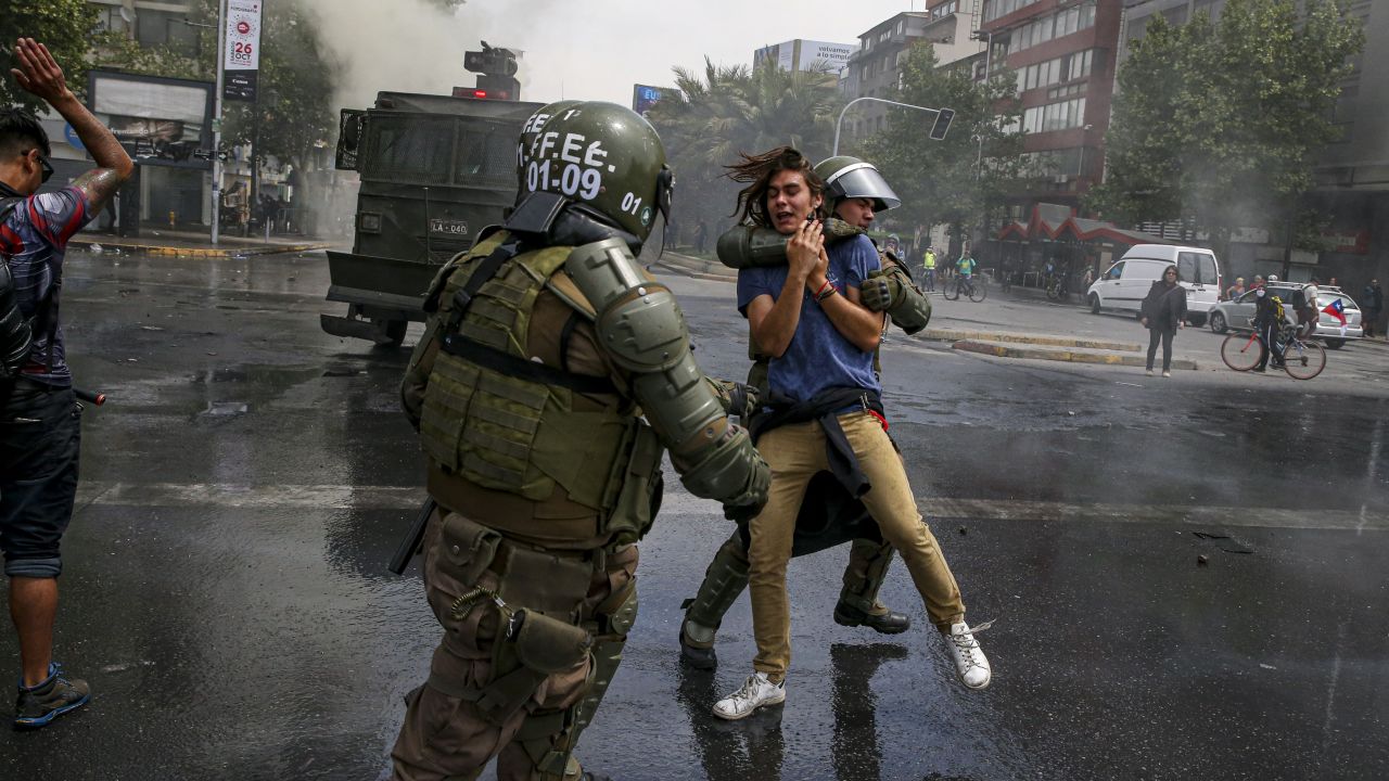 A demonstrator is detained by the police during a protest in Santiago, Chile, Saturday, October 19, 2019. 