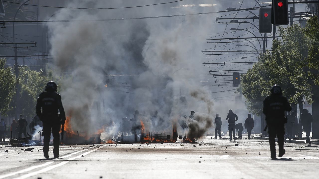 Demonstrators clash with riot police during protests in Valparaiso, Chile, on October 20, 2019.