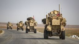 US military vehicles drive on a road after US forces pulled out of their base in the Northern Syrian town of Tal Tamr, on October 20, 2019. - US forces withdrew from a key base in northern Syria today, a monitor said, two days before the end of a US-brokered truce to stem a Turkish attack on Kurdish forces in the region. (Photo by Delil SOULEIMAN / AFP) (Photo by DELIL SOULEIMAN/AFP via Getty Images)