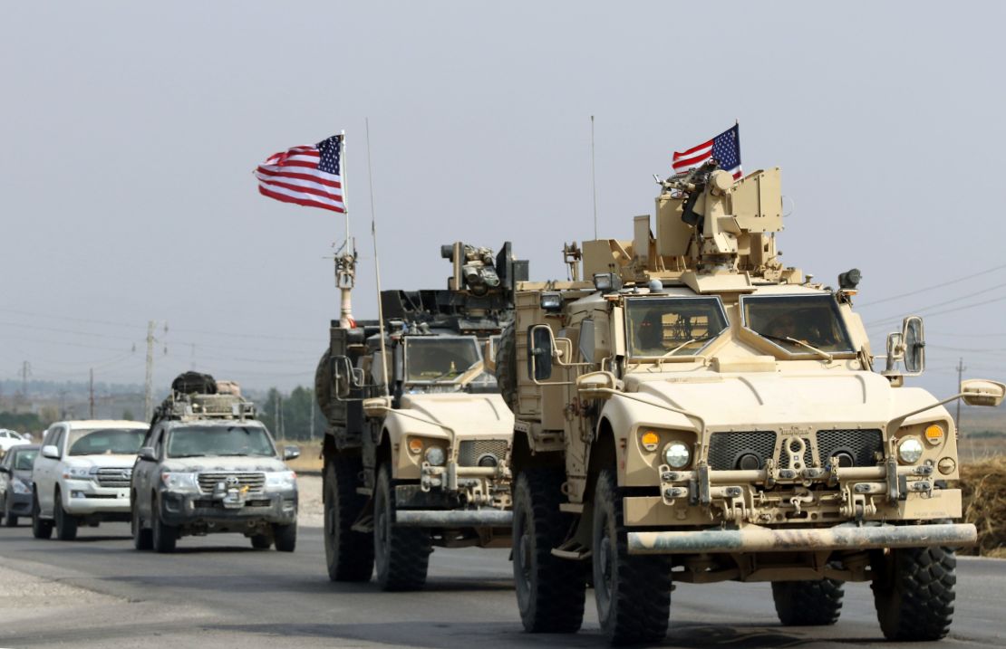 A convoy of US military vehicles arrives near the Iraqi Kurdish town of Bardarash after withdrawing from northern Syria.