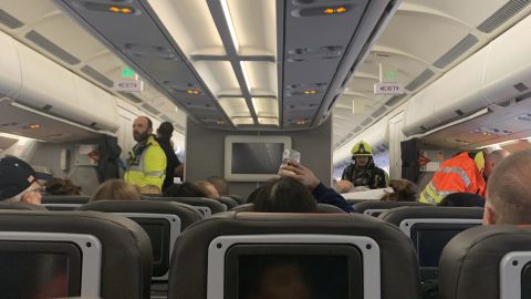 A photo sent to CNN by passenger Katie Phillips shows emergency personnel on the plane.