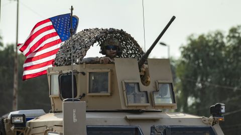 A US soldier stands in an armoured personnel carrier as the US forces pull out of their base in the Northern Syrian town of Tal Tamr, on October 20, 2019. - US forces withdrew from a key base in northern Syria today, a monitor said, two days before the end of a US-brokered truce to stem a Turkish attack on Kurdish forces in the region. (Photo by Delil SOULEIMAN / AFP) (Photo by DELIL SOULEIMAN/AFP via Getty Images)