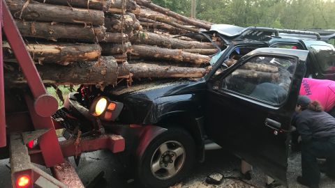 01 car impaled by log truck