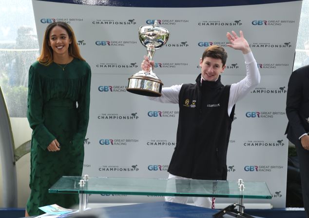 Heptathlon world champion Katarina Johnson-Thompson presents Oisin Murphy with the champion jockey award at British Champions Day at Ascot.