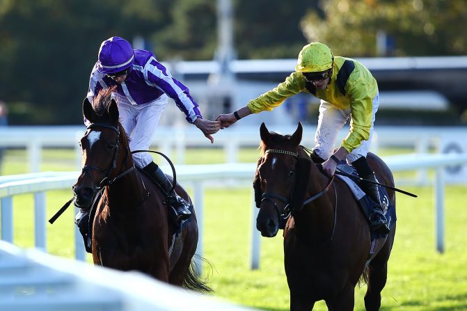 Donnacha O'Brien on Magical (left) is congratulated by second place James Doyle on Addeybb after winning the QIPCO Champion Stakes.