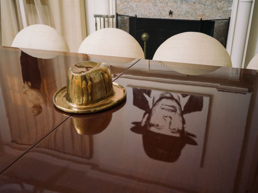 Andy Warhol's "Diamond Dust Joseph Beuys" is seen in a reflection next to Sherrie Levine's sculpture, "Fedora." The American artist, who is of no relation to the pair.