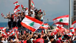 Anti-government protesters chant slogans and wave their national flags at Martyr's Square, in downtown Beirut, Lebanon, Sunday, Oct. 20, 2019. Lebanon is bracing for what many expect to be the largest protests in the fourth day of anti-government demonstrations. Thousands of people of all ages were gathering in Beirut's central square Sunday waving Lebanese flags and chanting the, "people want to bring down the regime." (AP Photo/Hussein Malla)