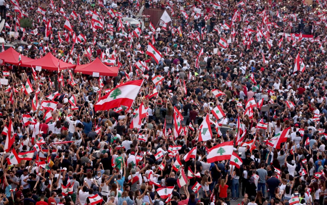Demonstrators wave national flags during a rally in downtown Beirut on Sunday.