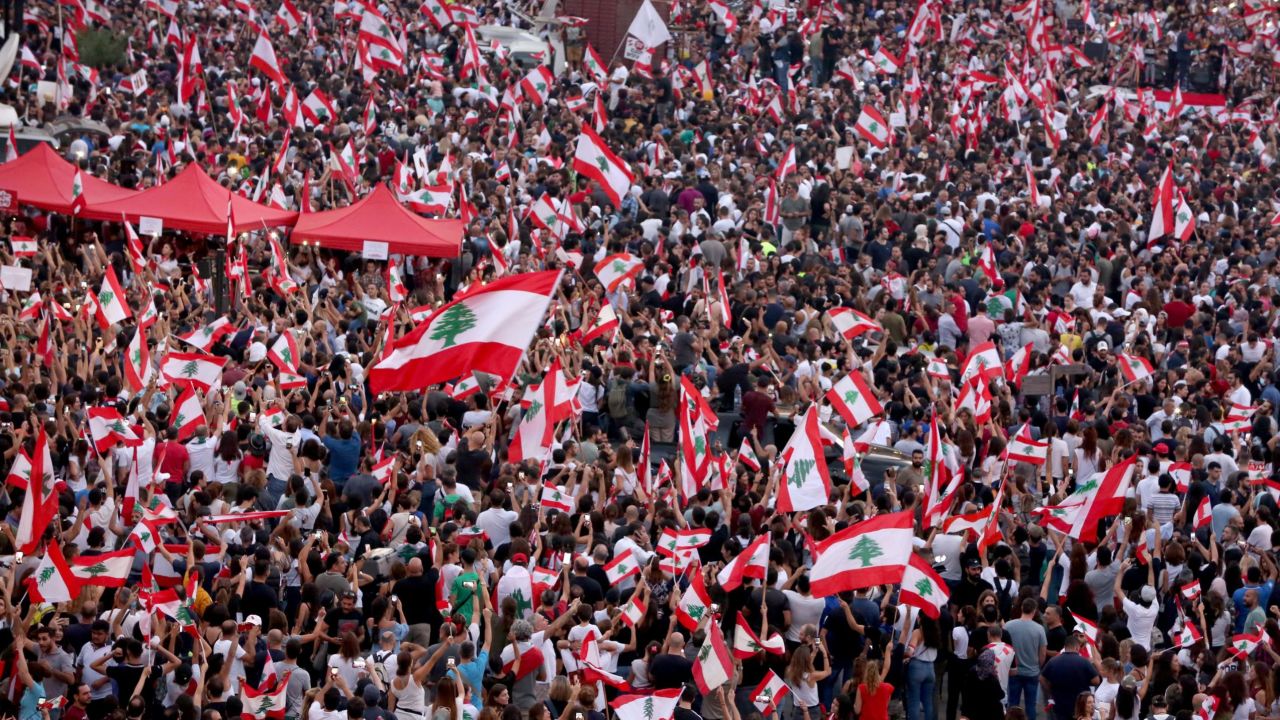 Demonstrators wave national flags during a rally in downtown Beirut on Sunday.