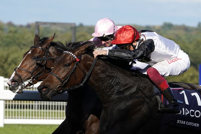 Frankie Dettori riding Star Catcher (red cap) battles with Delphinia and Seamie Heffernan (pink) to win the Qipco British Champions Fillies & Mares Stakes during British Champions Day.