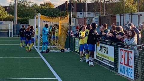 Haringey players shake hands with supporters.
