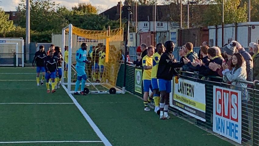 Haringey players shake hands with their supporters.