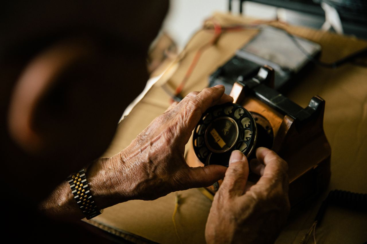 Harry Ang fixing an old phone in his workshop. Ang fixes phonographs, gramophones and old phones. Singapore, 24 September 2019.