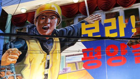 A partially-obscured piece of North Korea-style propaganda reads: "Look! It's the Pyongyang Pub!"